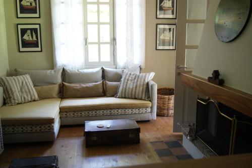 a living room with a couch and a fireplace at Villa Trypiti in Limenaria