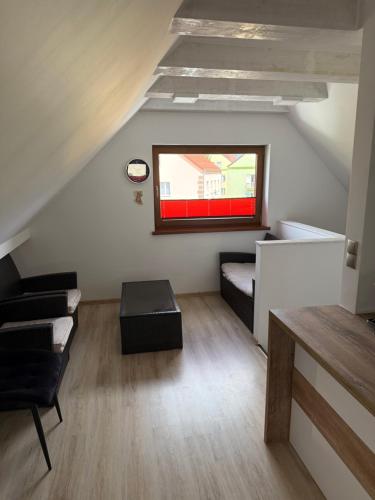 a living room with a couch and a window at Apartament Nowa in Bolesławiec