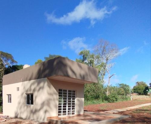 a small white building with a roof at Rincon Amanay in Puerto Esperanza
