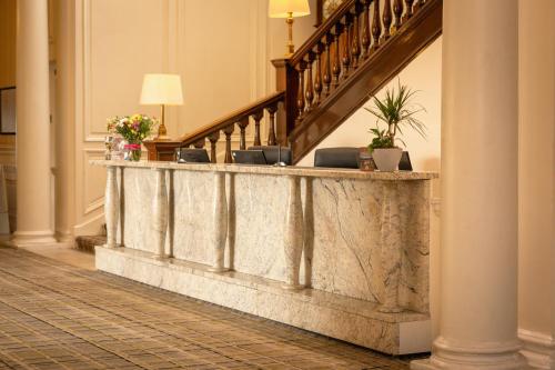 a stone retaining wall in a hallway with stairs at Peebles Hydro in Peebles