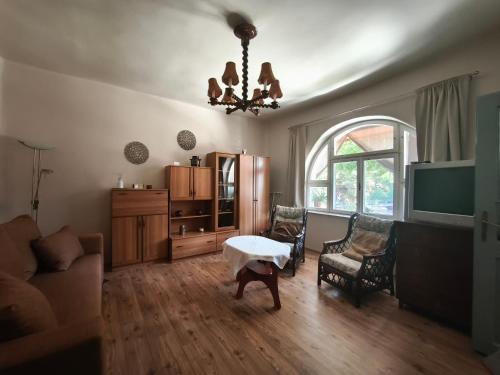 a living room with a couch and a table at Anna Vendégház in Kápolnásnyék