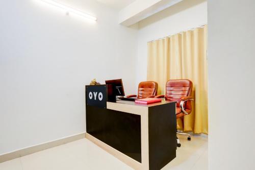 an office with two chairs and a desk with a sign on it at Hotel O AAGAMAN HOTEL & RESTAURANT in Begusarai