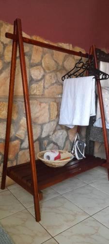 a towel rack with a basket and towels on a wall at Miji Lake Victoria Room in Jinja