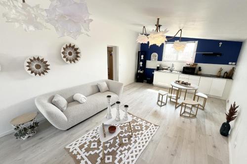 a living room with a couch and a table at The Amantis suite XXL Bath and Sauna in Mauguio in Mauguio