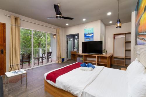a bedroom with a large bed with a flat screen tv at Ocean Villa Ukulhas Hotel & Spa in Ukulhas