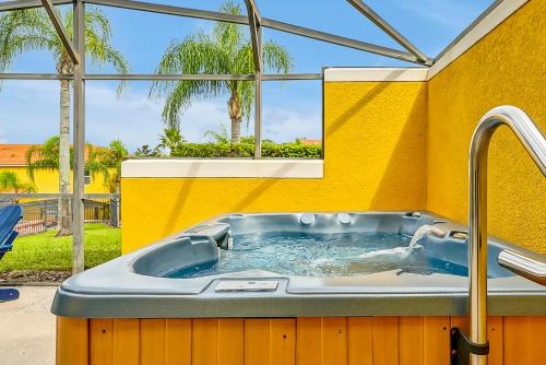 a hot tub in a room with a yellow wall at Encantada Resort Vacation Townhomes by IDILIQ in Kissimmee