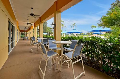a row of tables and chairs on a patio at Encantada Resort Vacation Townhomes by IDILIQ in Kissimmee