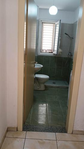 a bathroom with a toilet and a sink at Qetesia Apartment in Shkodër