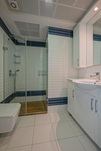 a bathroom with a shower and a sink and a toilet at Citrus Park Hotel in Antalya