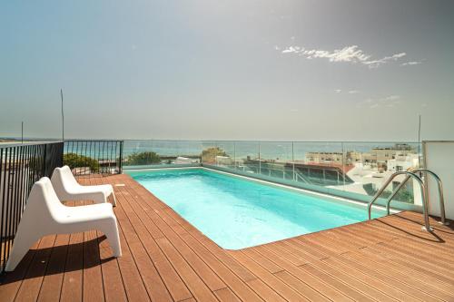 a swimming pool on the deck of a building at HENRI'S APARTMENTS - Pateo de Santo António in Lagos
