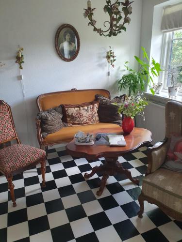 a living room with a couch and a coffee table at Pegasus Bed & Breakfast in Hillerød