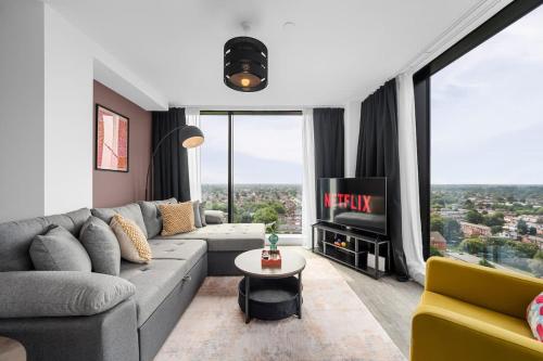 a living room with a couch and a tv at Skyline Old Trafford flat by City SuperHost in Manchester