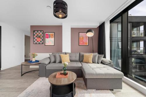 a living room with a couch and a table at Skyline Old Trafford flat by City SuperHost in Manchester