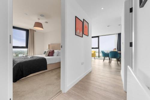 a bedroom with a bed and a dining room at Skyline Old Trafford flat by City SuperHost in Manchester