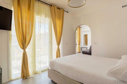 a bedroom with a bed and a large window at Actus Palace Rooms by Ghor in Rome