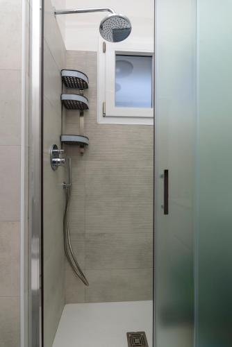 a shower in a bathroom with a glass door at Actus Palace Rooms by Ghor in Rome