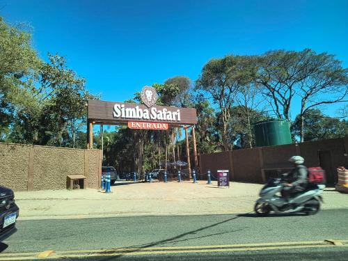 a person riding a motorcycle in front of a sign at Expo SP, Jd botânico, Jd zoológico, centro paraolímpico in Sao Paulo