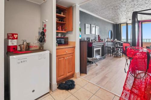 a kitchen with a refrigerator and a dining room at Couples Retreat 409 in Myrtle Beach