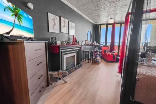 a living room with a fireplace and a living room with at Couples Retreat 409 in Myrtle Beach