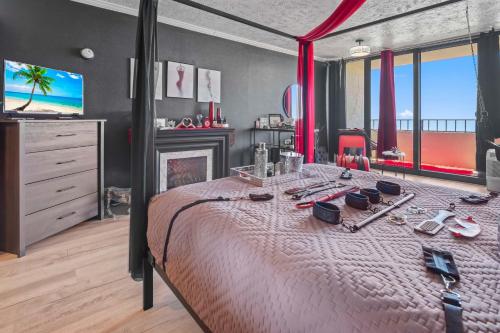 a bedroom with a bed with a fireplace and a television at Couples Retreat 409 in Myrtle Beach
