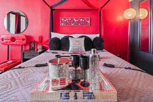 a bedroom with a bed with a red wall at Couples Retreat 409 in Myrtle Beach