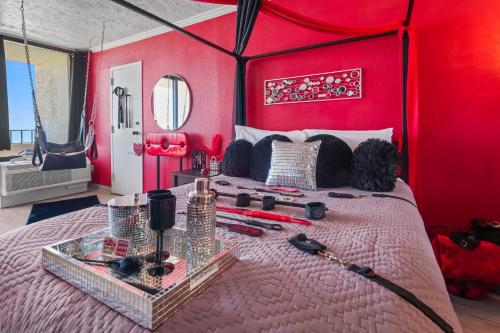 a bedroom with a bed with a red wall at Couples Retreat 409 in Myrtle Beach