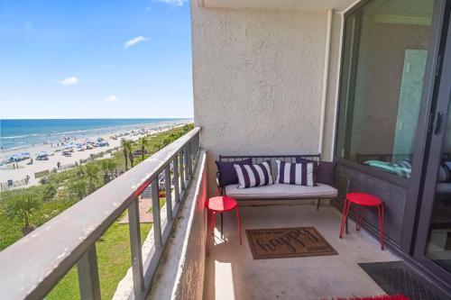 a balcony with a bench and a view of the beach at Couples Retreat 409 in Myrtle Beach