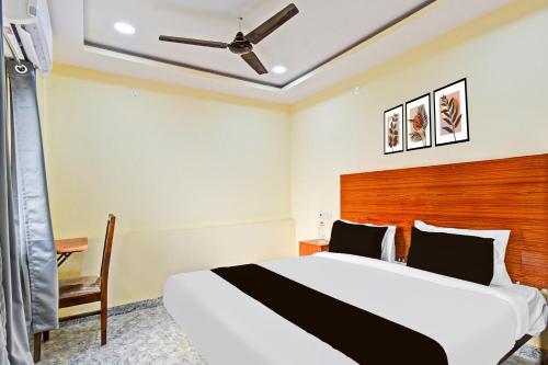 a bedroom with a bed and a ceiling fan at Super Hotel O Madlen in Hyderabad