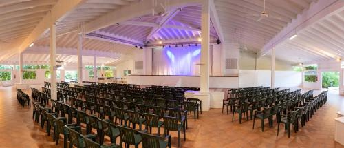 a room with rows of chairs in a church at Club Hotel Marina Beach in Orosei
