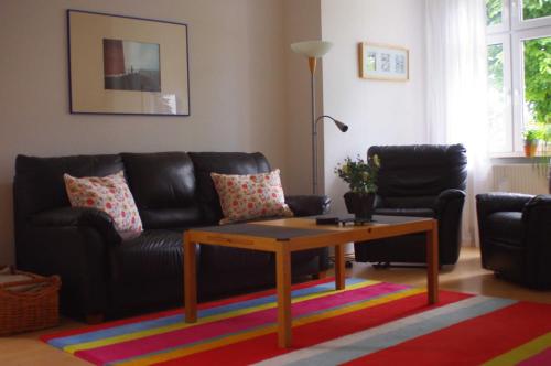 a living room with a couch and a coffee table at Ferienwohnung Bülow GM 69131 in Müritz