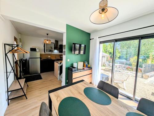 a kitchen and dining room with a table and chairs at La maison au bord de la riviére in Loches
