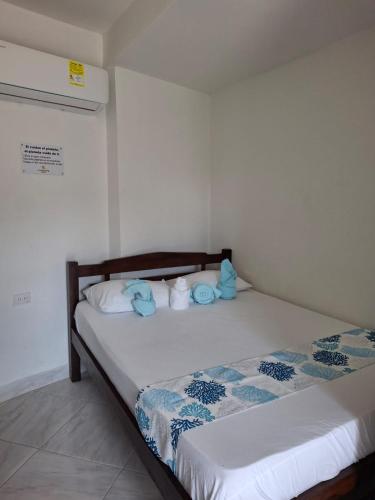 two beds in a room with blue towels on them at Cabañas Ana Sofía in San Antero