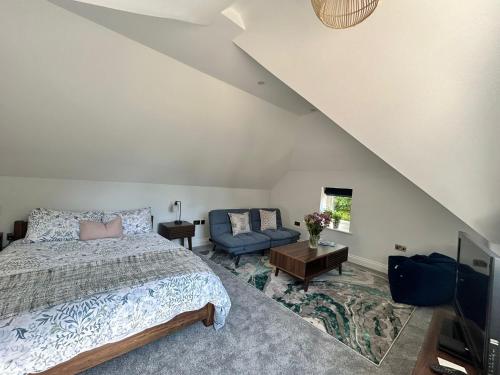 a bedroom with a bed and a couch at Goring River Retreat with Gym and Wellness Area in Goring