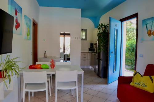 a kitchen and living room with a table and chairs at Villaggio Mare Blu in Bibione