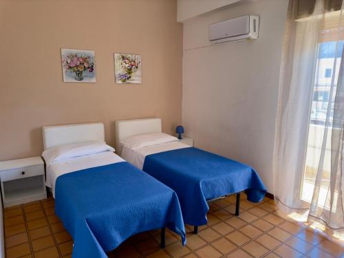 Postel nebo postele na pokoji v ubytování Poseidon Bay Residence