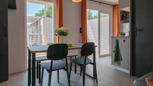 a dining room with a table and four chairs at Camping Grande Italia in Chioggia