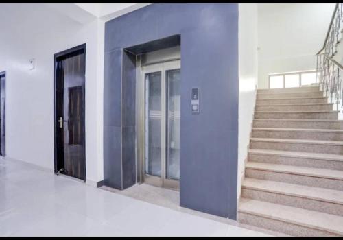 a staircase in a building with a blue wall at Hotel Star Near railway station in New Delhi