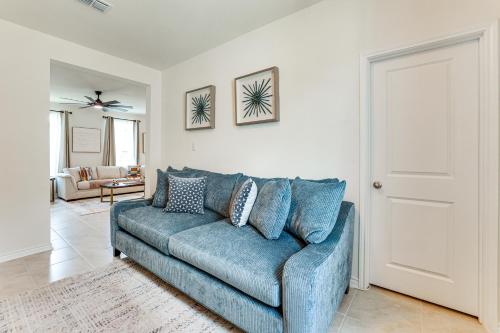 a blue couch in a living room with at 12 Mi to San Antonio River Walk Home with Yard! in Elmendorf