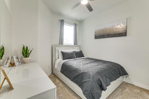 a bedroom with a bed and a ceiling fan at 12 Mi to San Antonio River Walk Home with Yard! in Elmendorf