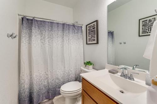 a bathroom with a sink and a toilet and a shower at 12 Mi to San Antonio River Walk Home with Yard! in Elmendorf
