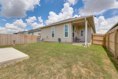 a house with a fence in a yard at 12 Mi to San Antonio River Walk Home with Yard! in Elmendorf