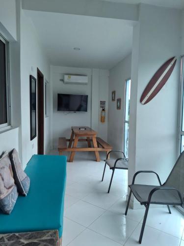 a living room with a blue couch and a table at Cabañas Ana Sofía in San Antero