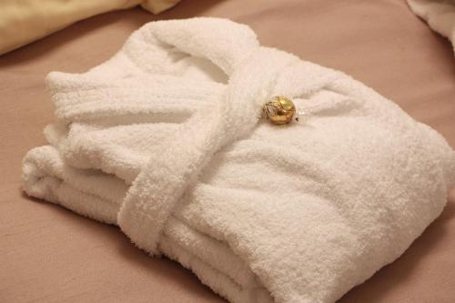 a white towel with a ring on top of it at Mr.& Mrs. President in Erfurt