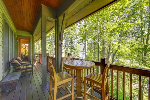 a porch with a wooden table and chairs at Lake and Pool Access at Bear Lake Reserve Condo! in Tuckasegee