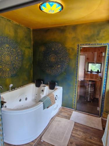 a bathroom with a tub and a mirror at Ponte Fontana in Campiglia Cervo