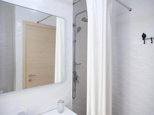 a bathroom with a shower and a mirror at Alona's Apartments in Haifa
