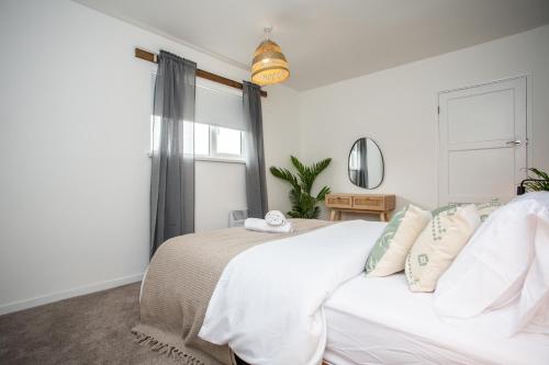 a bedroom with a white bed and a window at Vacant Nest The South End Spacious Smart Tv in Kielder
