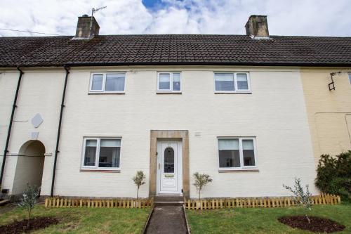 a white house with a white door at Vacant Nest The South End Spacious Smart Tv in Kielder