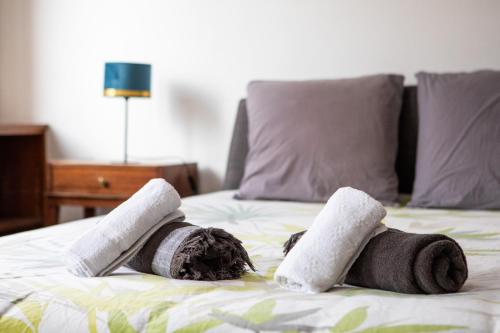 two rolled towels on top of a bed at Two room apartment - centre historique in Mulhouse