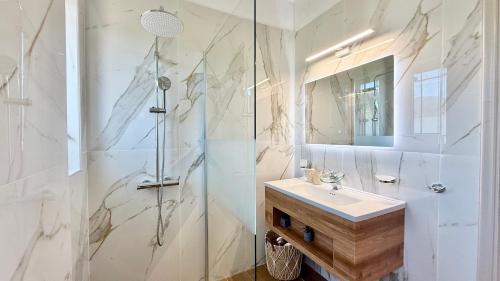 a white bathroom with a sink and a shower at Free Spirit Joy in Kalamata